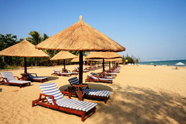Sunshade and chairs on beach, Sanya, China Royalty Free Stock Photos