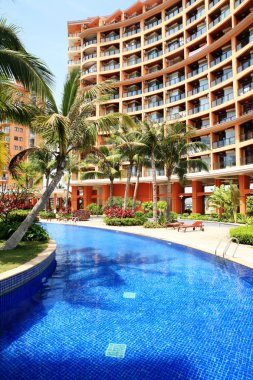 Swimming pool in china hotel with palm trees. china,Sanya clipart