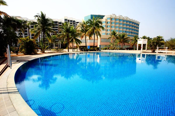 stock image Swimming pool in china hotel with palm trees. china,Sanya