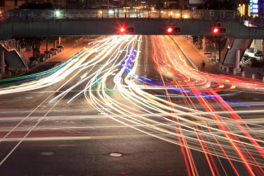 Light traces on crossroad at night clipart