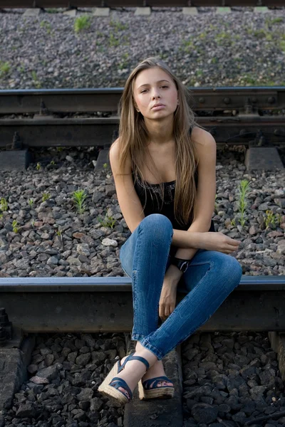 Flicka sitter på räls — Stockfoto