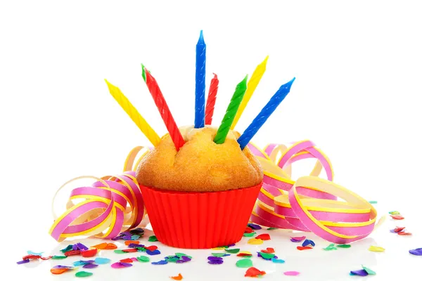 Birthday cupcake with lots of candles, party streamers and color — Stock Photo, Image