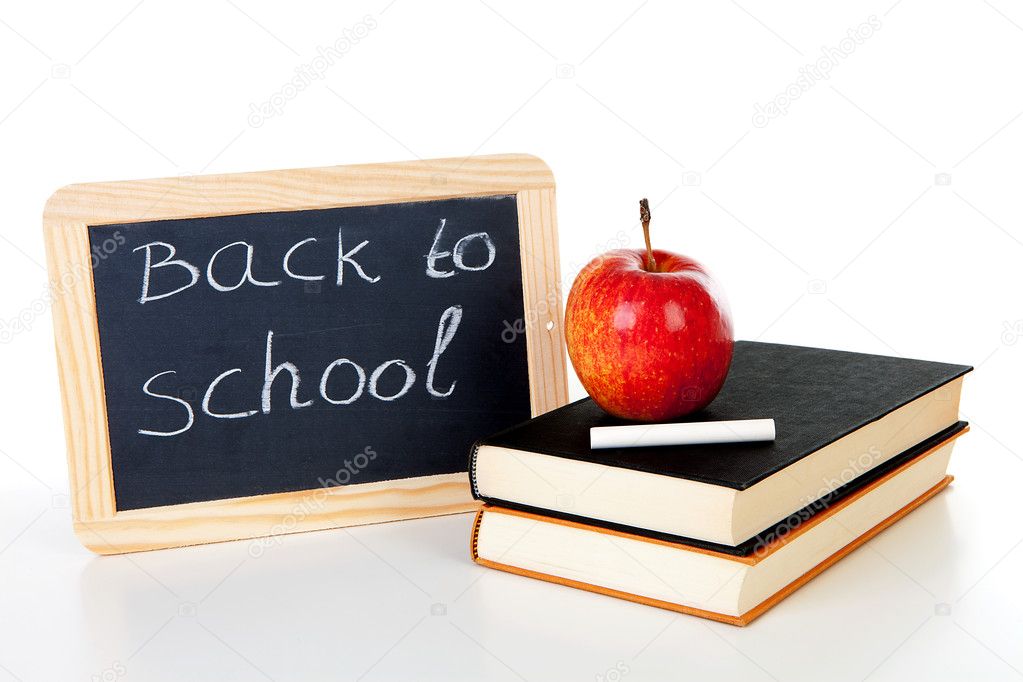 Blackboard slate and stack of books with apple on top