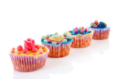 Row cupcakes with marzipan decoration clipart