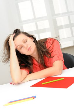 Portrait of beautiful tired business woman sleeping at her workp clipart