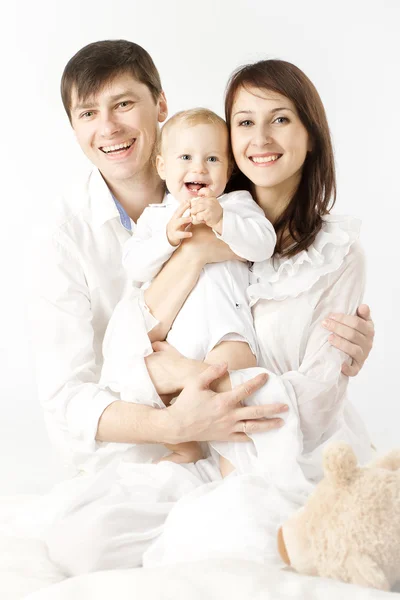 Happy family holding smiling baby — Stok fotoğraf