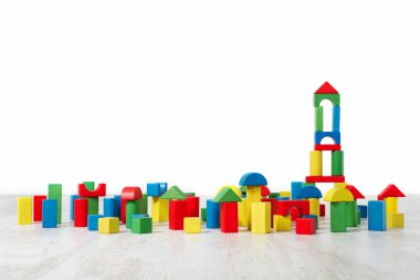Building blocks toy over floor in white empty interior. Children