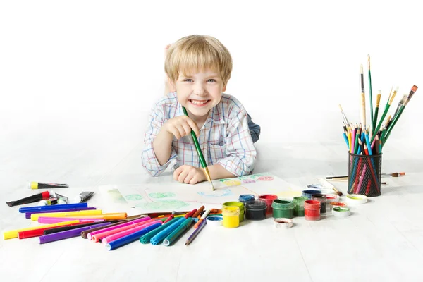 Happy cheerful child drawing with brush in album — Stock Photo, Image