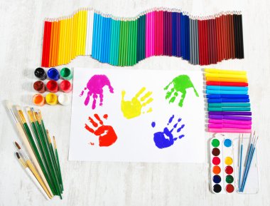 Painting tools set and multicolor child hand prints. Creativity clipart