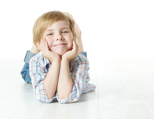 Smiling child lying down, looking at camera — Stock Photo, Image