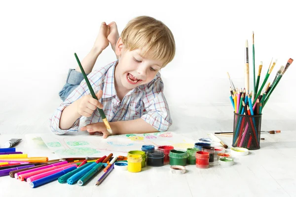 Happy child drawing with brush by multicolor paints — Stock Photo, Image