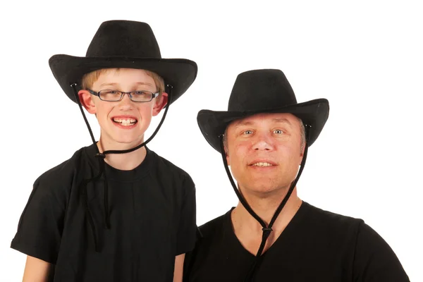 Muž a dítě s kovbojské klobouky — Stock fotografie