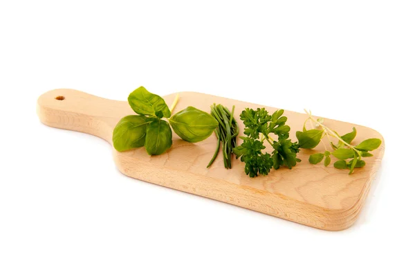 Cutting board with fresh herbs — Stock Photo, Image
