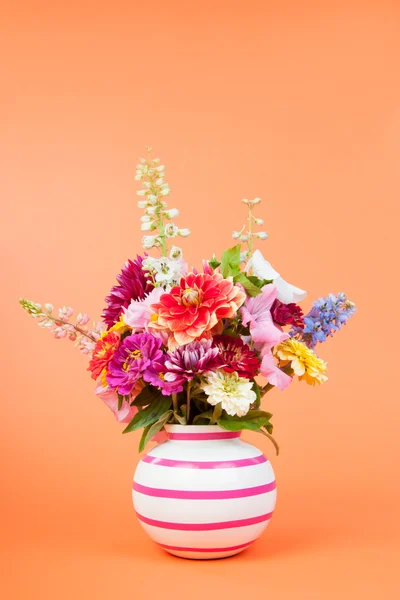 Colorful garden bouquet on orange background — Stock Photo, Image