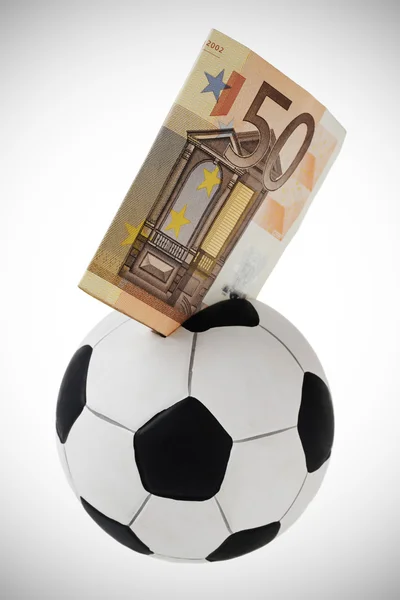 stock image Fifty euro going into football money box