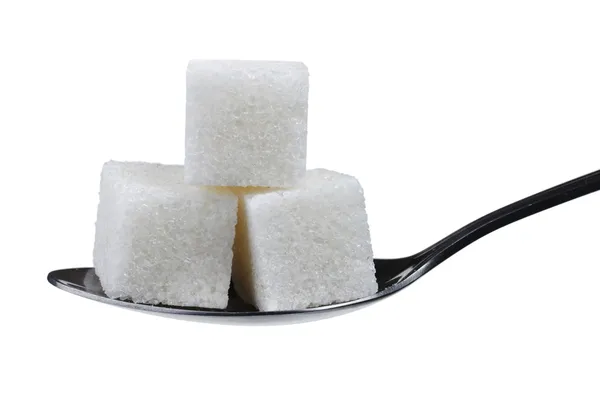 Spoonful of sugar cubes — Stock Photo, Image