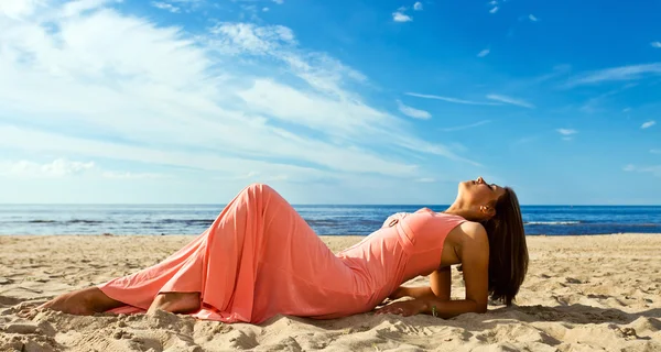 Kobieta w różowej sukience na wybrzeże — Zdjęcie stockowe