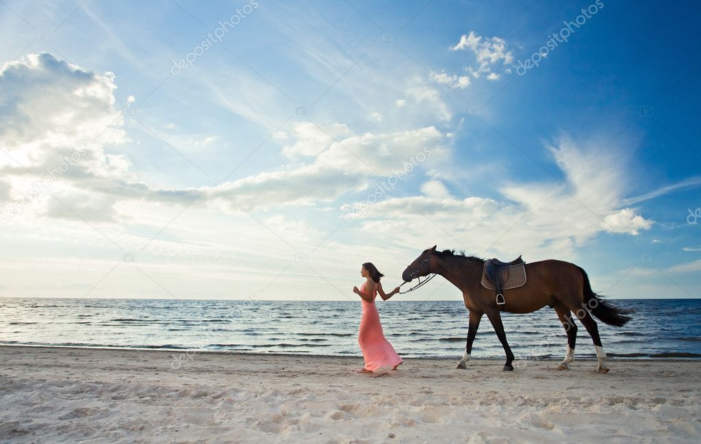 Beautiful girl with horse on seacoast