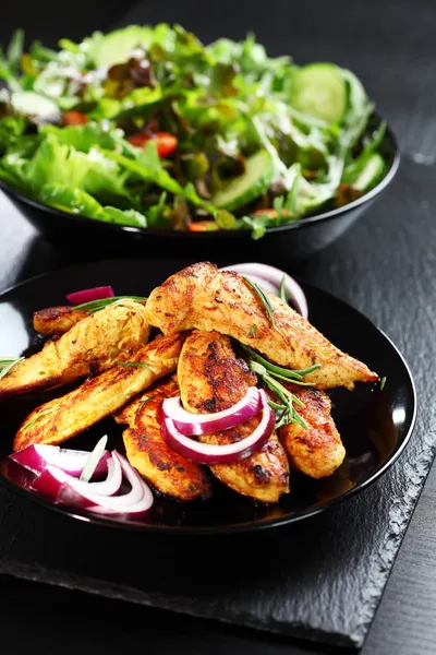 Marinated chicken breast stripes with salad — Stock Photo, Image