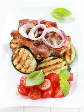 Pan-fried pork steak with grilled vegetable clipart