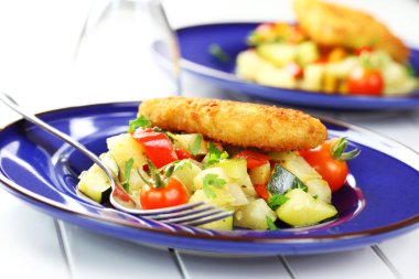 Fried fish on vegetables clipart