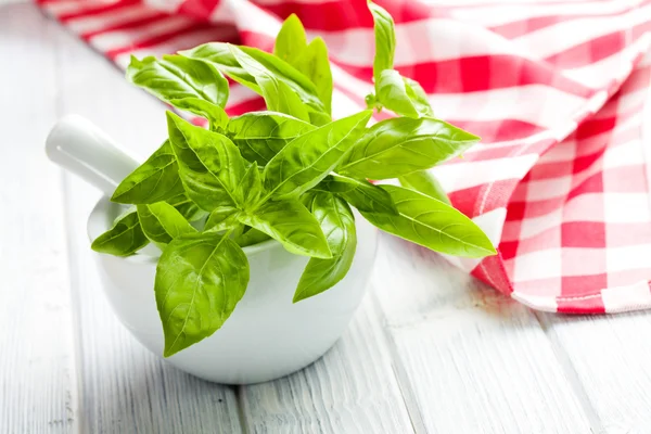 Fresh basil leaves in a mortar — Stock Photo, Image