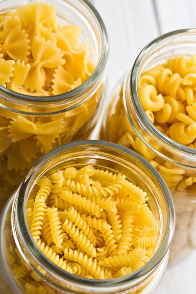 Various raw pasta in glass jar — Stock Photo, Image