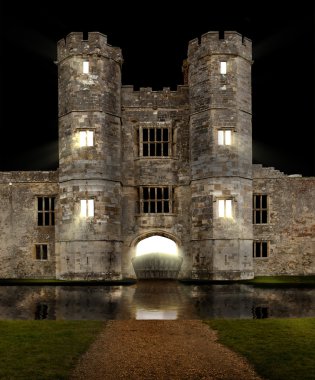 Castle at night with moat and lights shining clipart