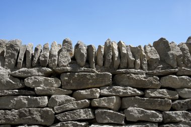 Dry-stone wall and blue sky clipart