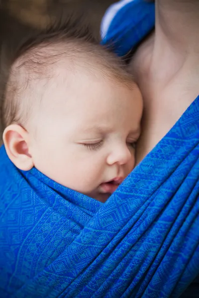 Sleeping newborn baby in the sling — Stock Photo, Image