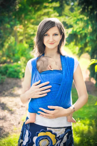 Mãe com bebê recém-nascido em uma funda — Fotografia de Stock
