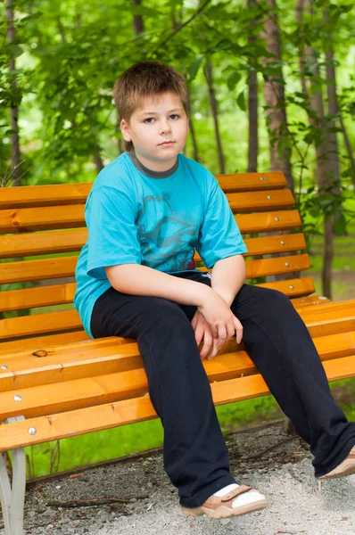 Rapaz triste num banco — Fotografia de Stock