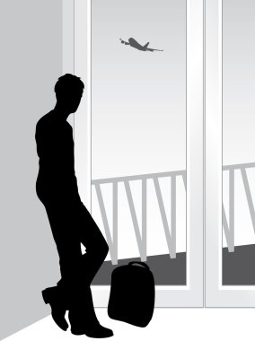 Silhouette of a traveler in anticipation of landing the airplane clipart