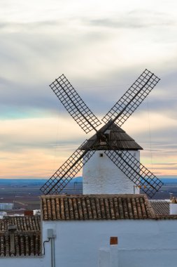 Old Spanish windmill at sunset