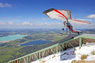 TEGELBERG, GERMANY - MAY 16: Competitor Ievgen Lysenko from Ukraine of the King Ludwig Championship hang gliding competitions takes part on May 16, 2012 in Tegelberg, Germany clipart