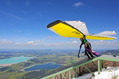 TEGELBERG, GERMANY - MAY 16: Competitor Conrad Duvig from Austria of the King Ludwig Championship hang gliding competitions takes part on May 16, 2012 in Tegelberg, Germany clipart