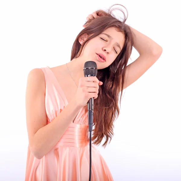 Nice teen girl with microphone, singing — Stock Photo, Image