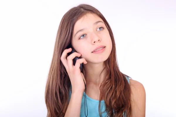Menina adolescente atraente falando no telefone sobre branco — Fotografia de Stock