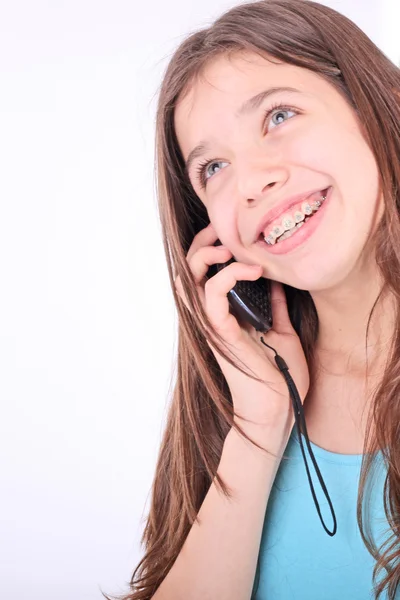 stock image Attractive teen girl talking on phone over white