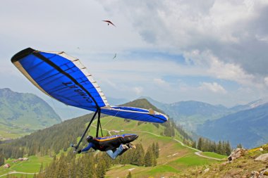 SANTS, SWITZERLAND - May 27: Competitor Ievgen Lysenko from Ukraine of the Swiss Masters hang gliding competitions takes part on May 27, 2012 in Sants, Switzerland clipart