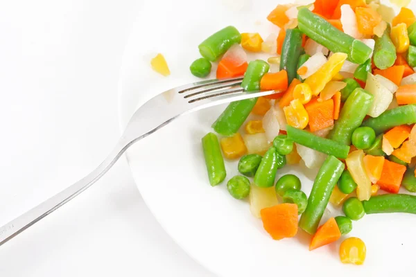 Mrożone warzywa i widelec na talerzu — Zdjęcie stockowe