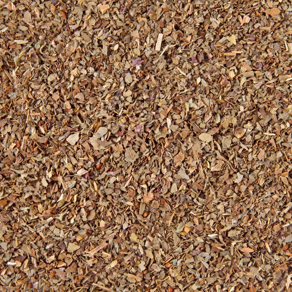 Pile of dried basil spice background — Stock Photo, Image