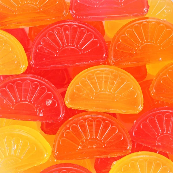 Kolorowe cukierki czerwone, żółte i pomarańczowe tło — Zdjęcie stockowe