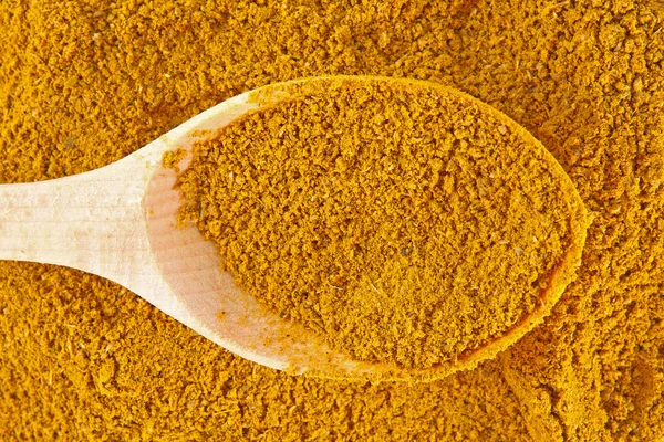 stock image Curry spice with wooden spoon