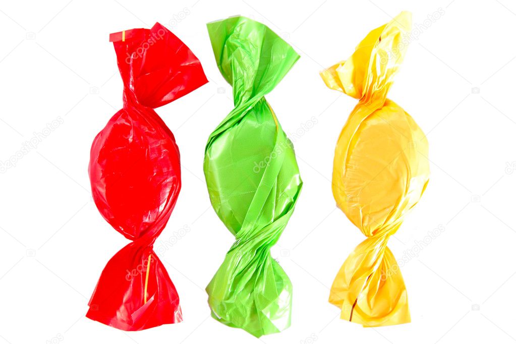 Yellow, red and green candies isolated on white background