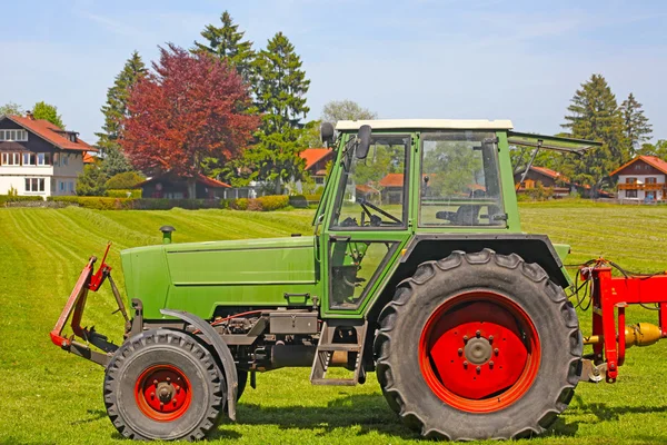 stock image Tractor plows a field in the spring