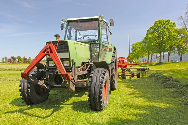 stock image Tractor plows a field in the spring