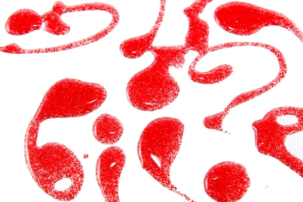 Red nail polish bottle with splatters isolated on white background — Stock Photo, Image