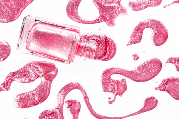 Pink nail polish bottle with splatters isolated on white background — Stock Photo, Image