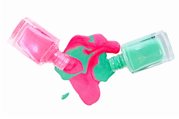 Close up de verniz de unha colorido derramado - rosa e verde claro — Fotografia de Stock